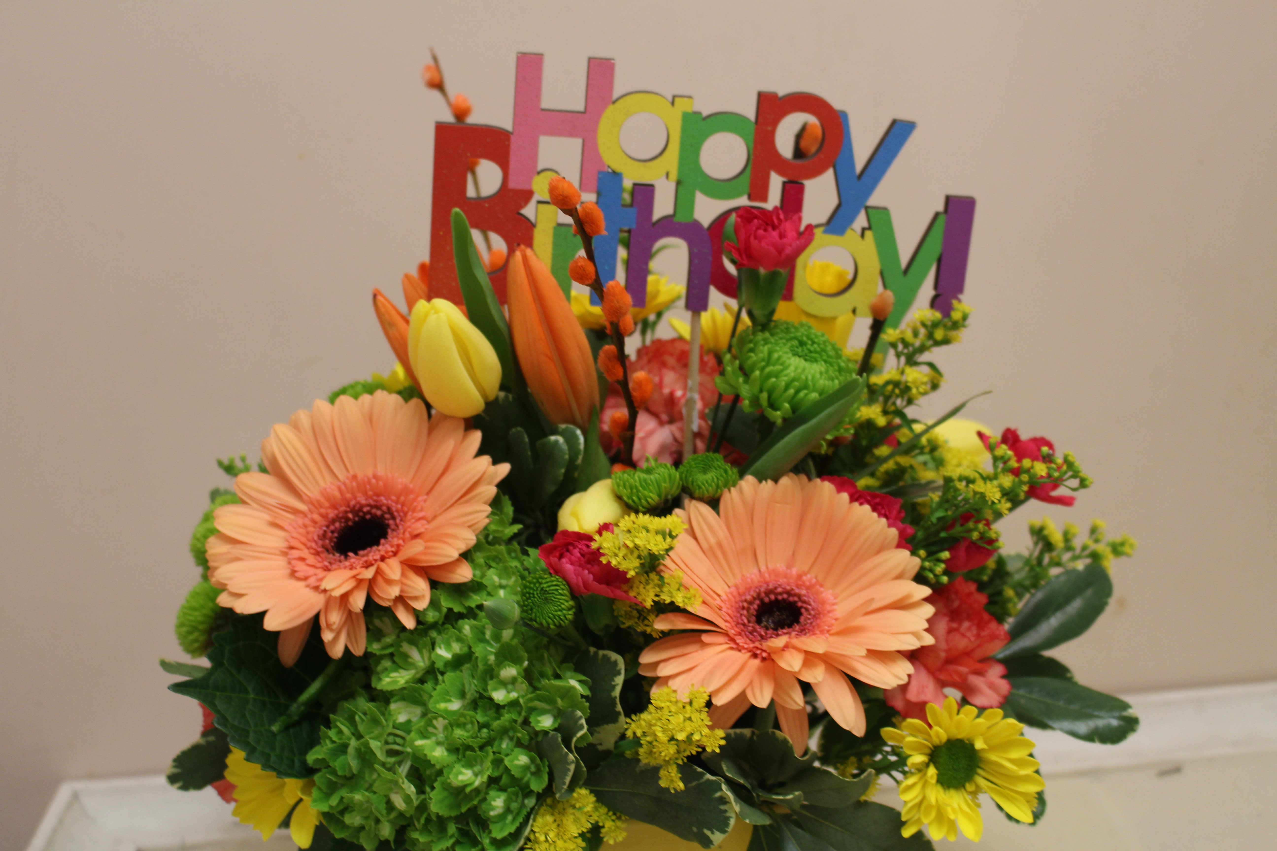 Colorful birthday bouquet with gerbera daisies and tulips