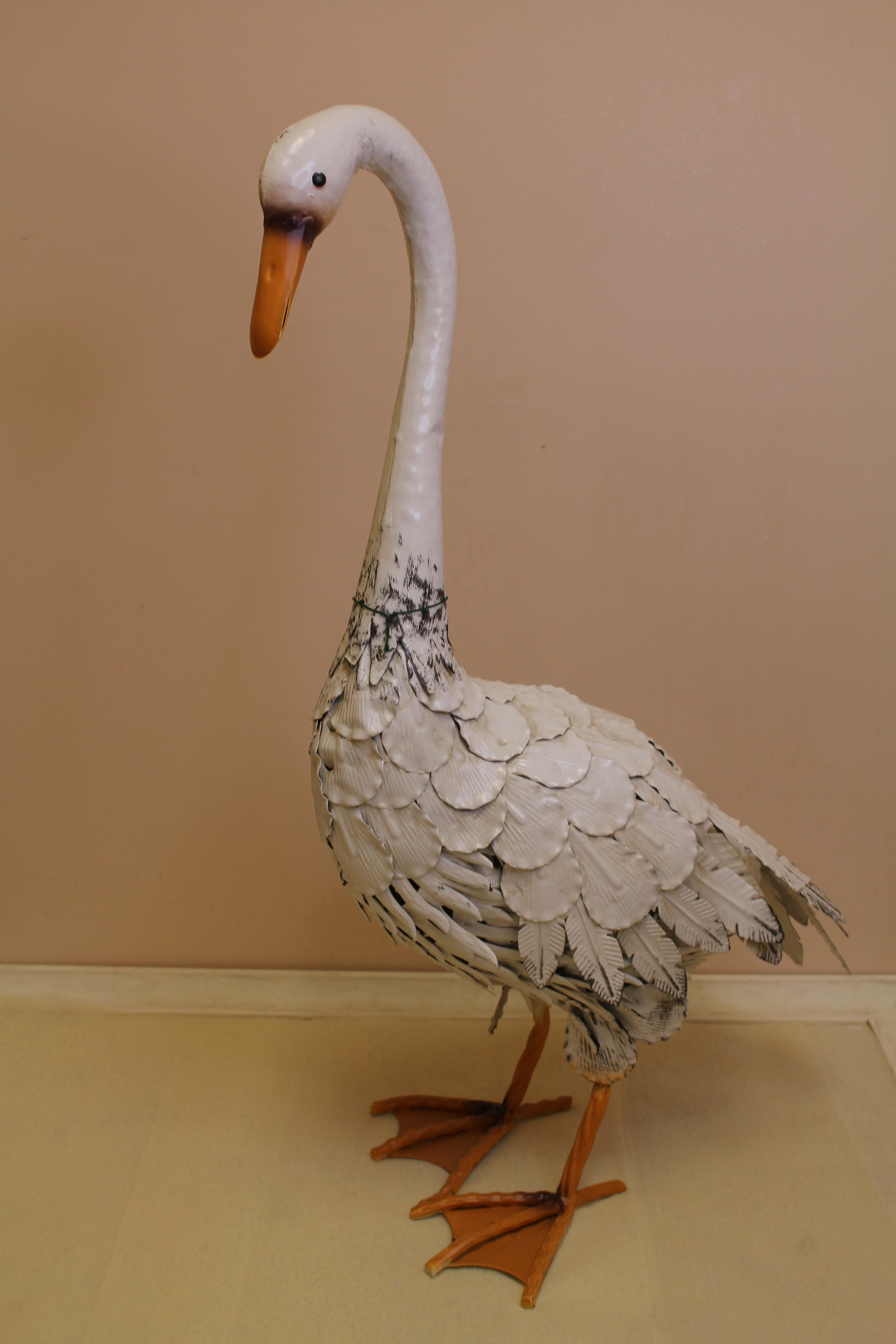 Decorative white swan figurine with orange beak and feet