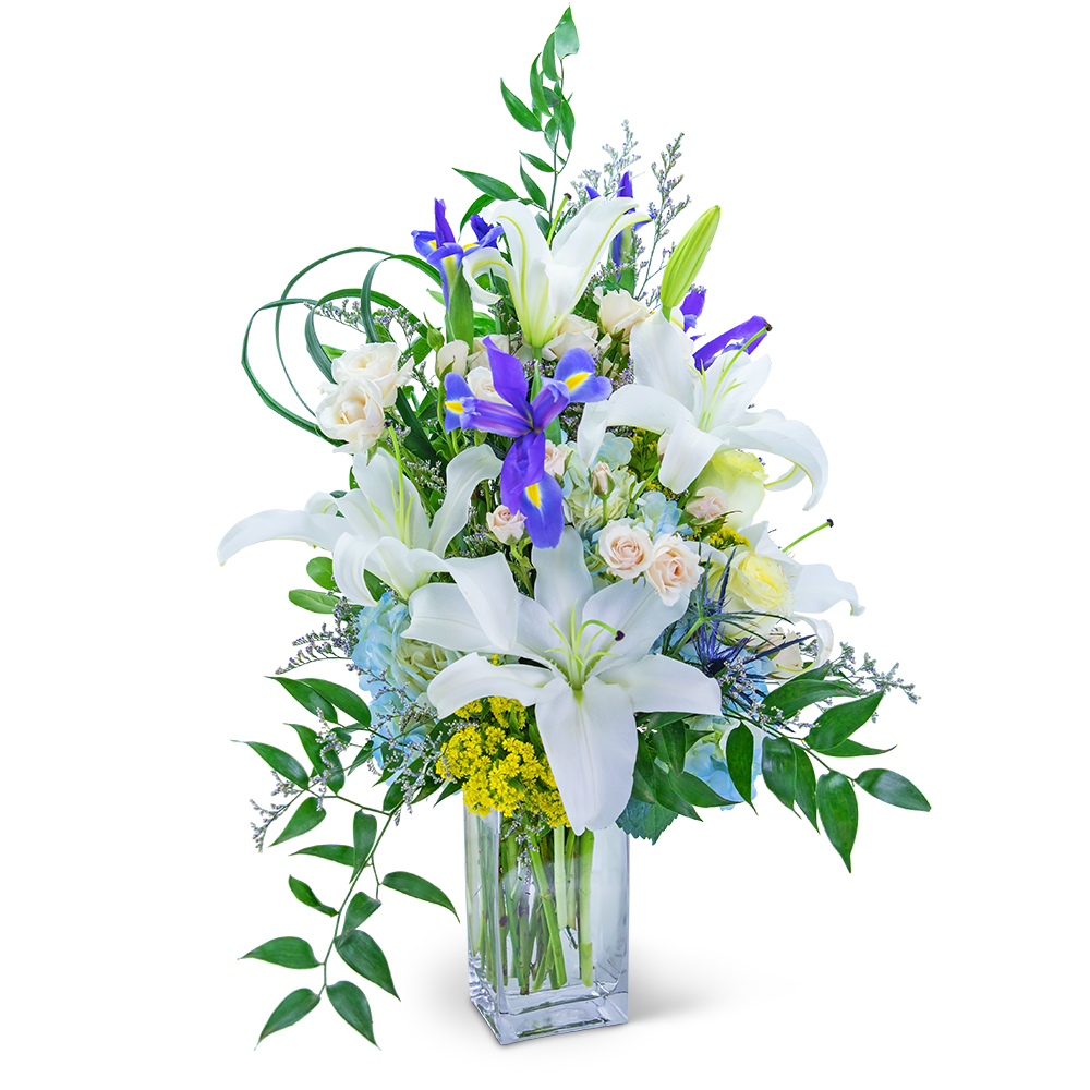 White lilies and purple irises in a clear glass vase