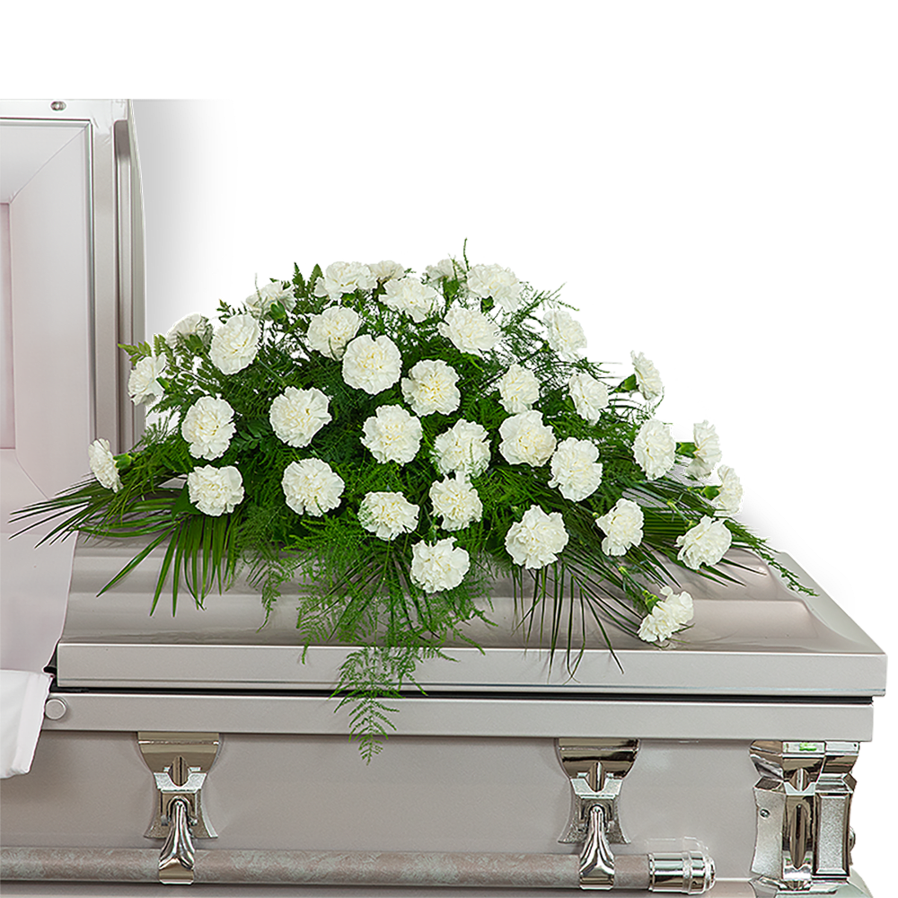 White floral casket spray with greenery on a silver casket