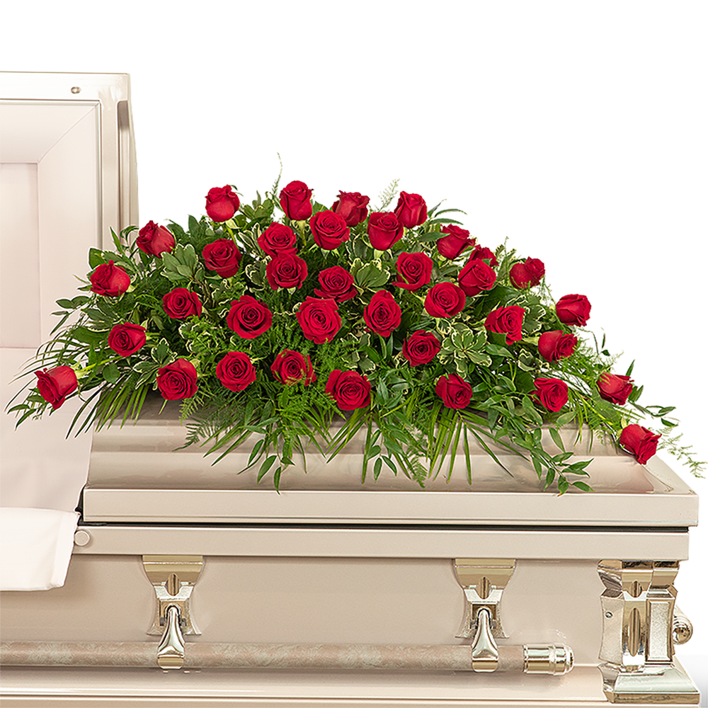 36 Red Roses Casket Spray - Our 36 Red Roses Casket Spray is a classic and beautiful choice for funeral flowers or a celebration of life ceremony. This stunning casket spray features 36 beautiful red roses and a variety of premium foliage, to be laid on the top of the casket. Red roses symbolize respect, love, and courage in a sympathy design. Funeral flowers are a meaningful way to celebrate the life of the deceased while providing comfort to the friends and family left behind.