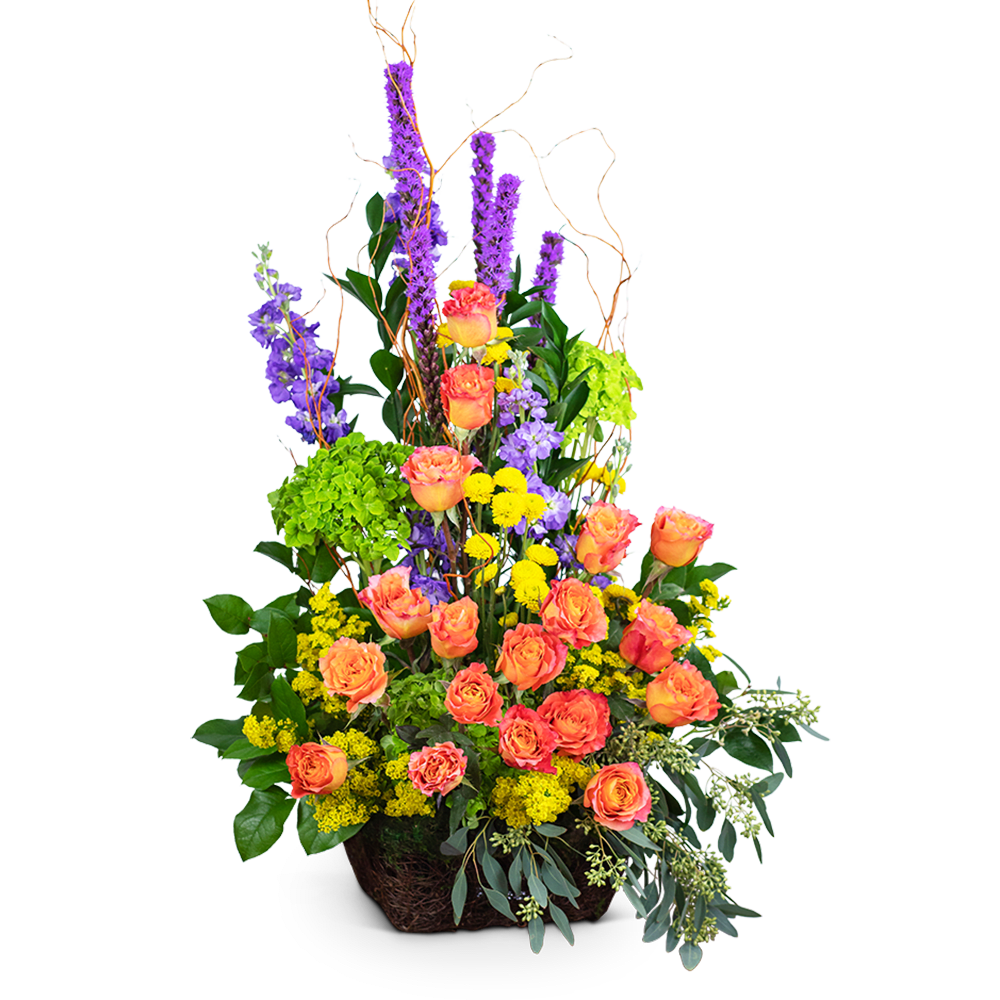Tall arrangement of orange roses, purple spikes, and yellow flowers in a basket