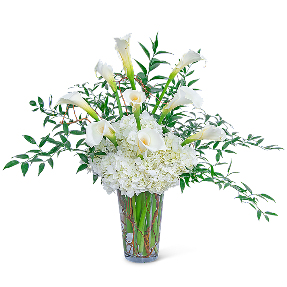 White calla lilies and hydrangeas in a clear glass vase