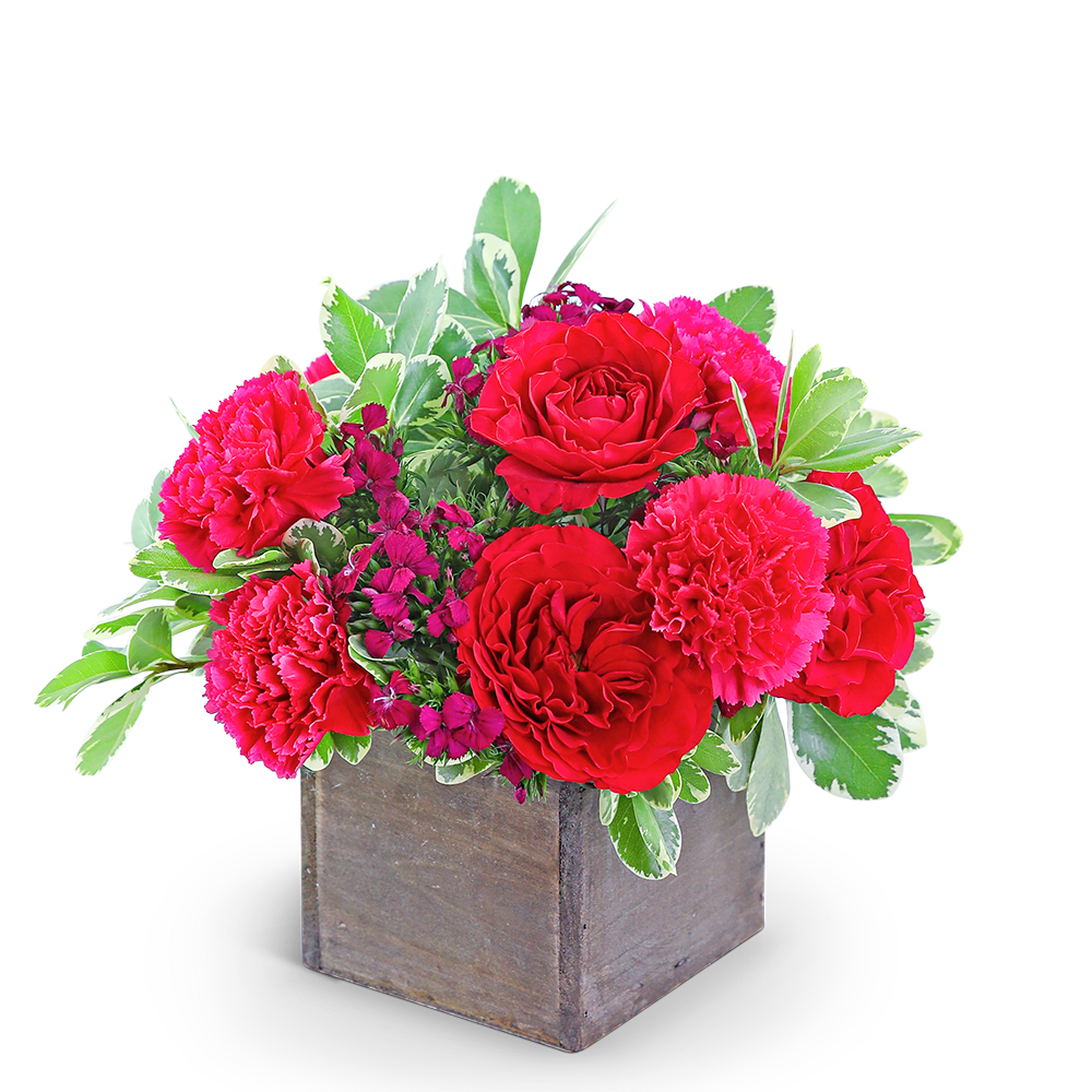 Red roses and pink carnations in a wooden box