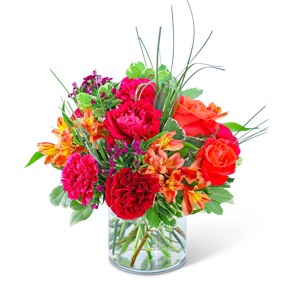 Bright mixed bouquet of roses, carnations, and alstroemeria in a glass vase