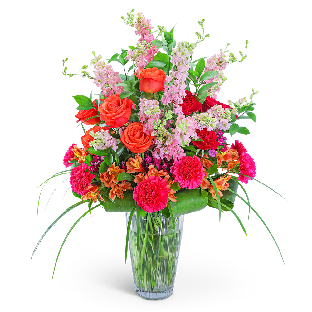 Mango Escape - Add bold color to your life with our Mango Escape design. Our hand-arranged, floral design is the perfect way to show someone special how much you care. It features gorgeous reds, pinks, and oranges in a combination of Roses, Carnations, Alstroemeria, Dianthus, Larkspur, and premium foliage. This elegant, colorful arrangement is the perfect statement piece for a large entryway or dining room table.