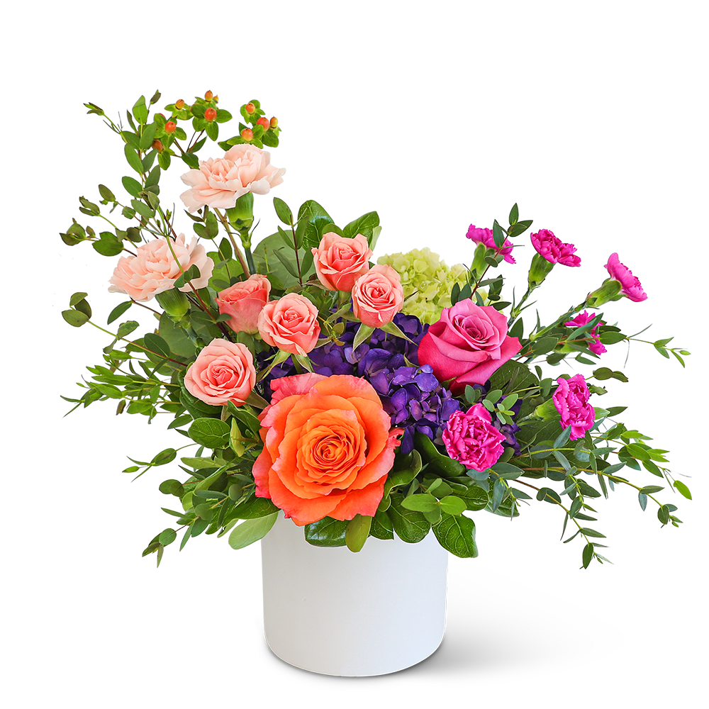 Mixed bouquet of roses, carnations, and hydrangeas in a white vase