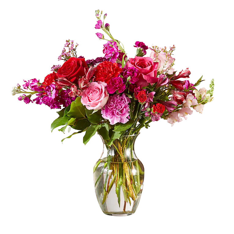 Mixed pink and red flower bouquet in a clear glass vase