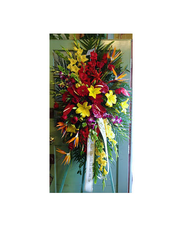 Tall standing floral spray with red, yellow, and orange flowers