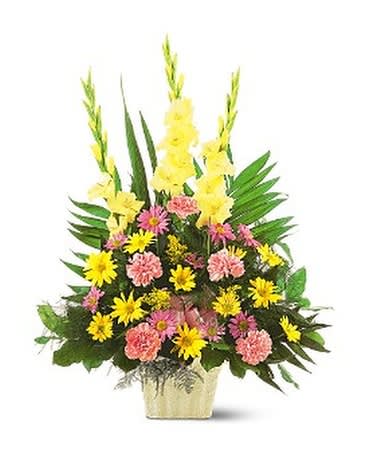 Tall mixed flower arrangement in a gold vase with yellow and pink blooms