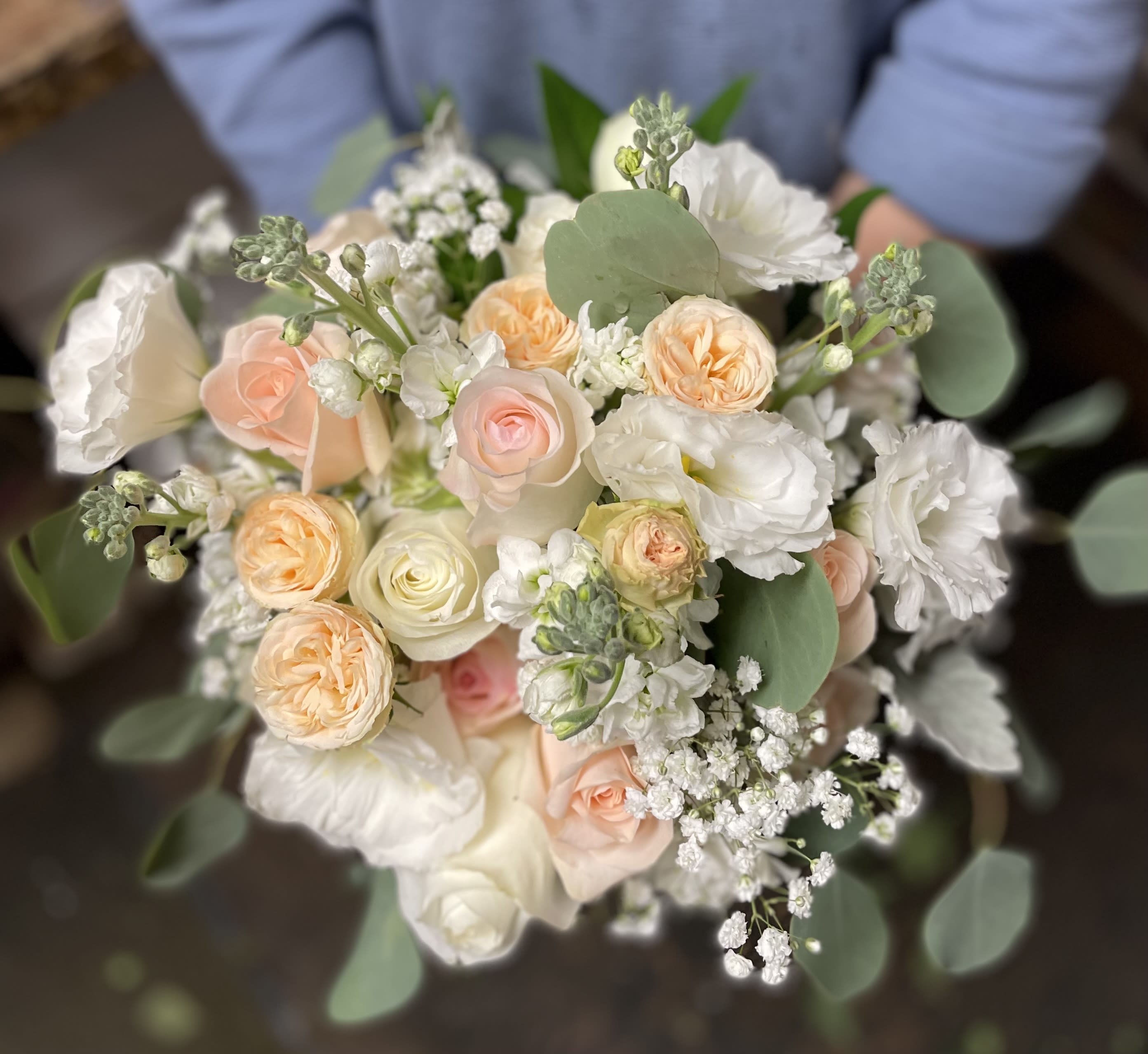 Bouquet of blush and white roses with white blooms and eucalyptus