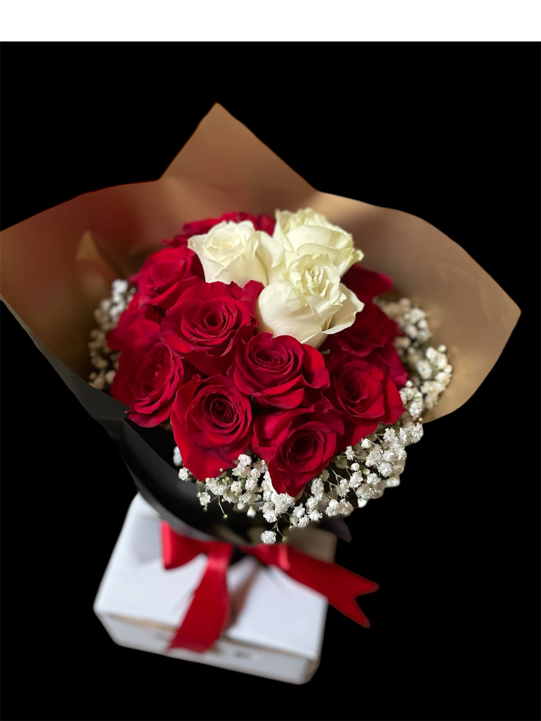 Bouquet of red and white roses with baby's breath in black and tan wrap