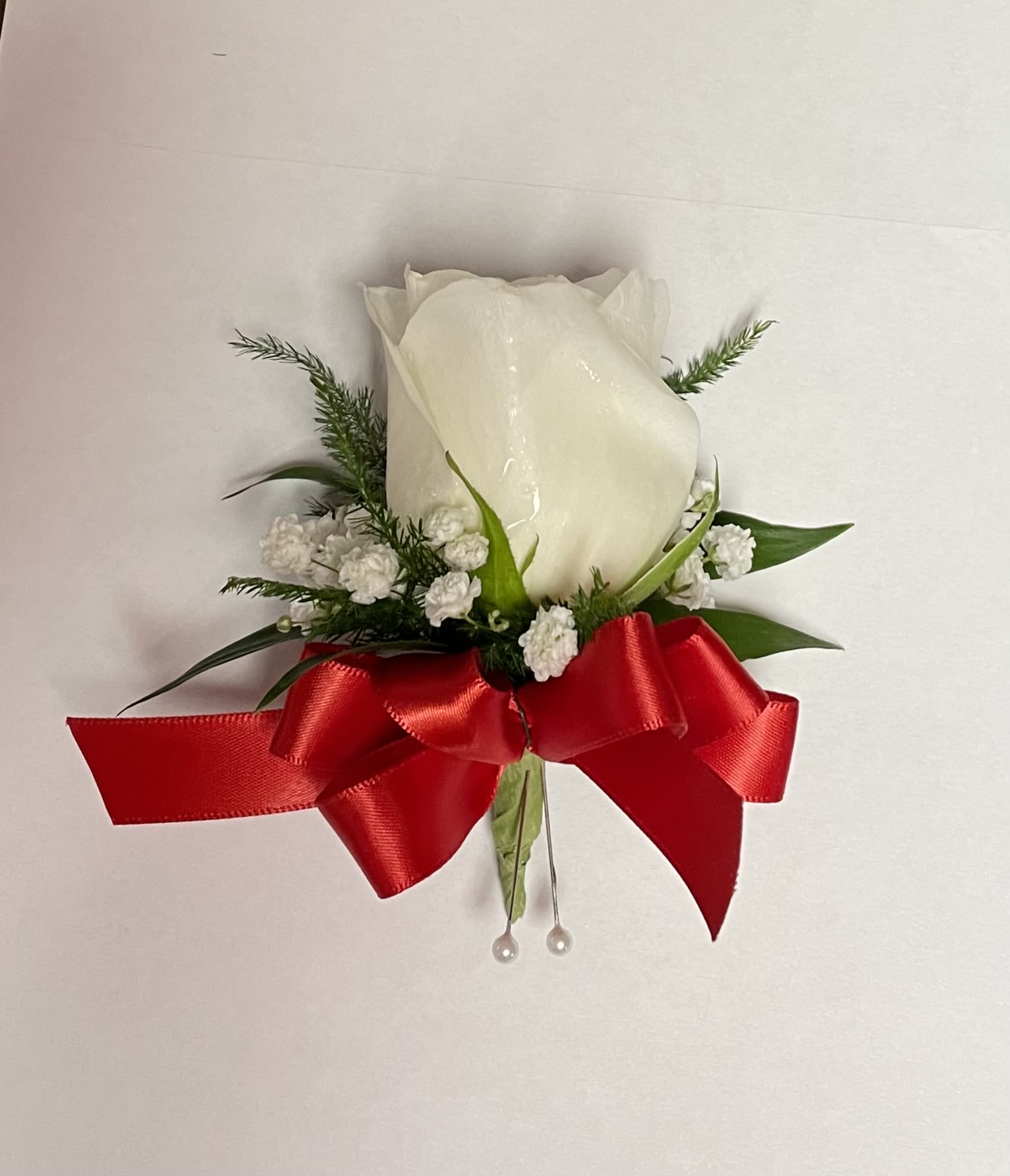 Boutonniere #6 - Single white rose with babybreath and a red bow.