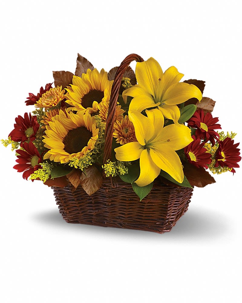 Basket arrangement with sunflowers, yellow lilies, and red daisies