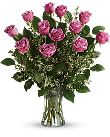 Pink roses arranged in a clear glass vase