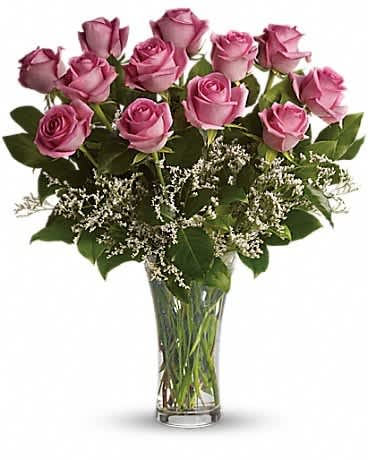 Make Me Blush - Dozen Long Stemmed Pink Roses - It's fun to be flirty! Send a dozen roses to the one you love and she just might make you blush. Especially if the dozen roses in question are this gorgeous! This arrangement is sweet and innocent as can be. Of course, it's a bit sassy and a whole lot sexy Sending a dozen perfectly pink roses and white limonium arranged in a glass vase to the woman you love shows that you know how much fun love is! And every woman appreciates that!