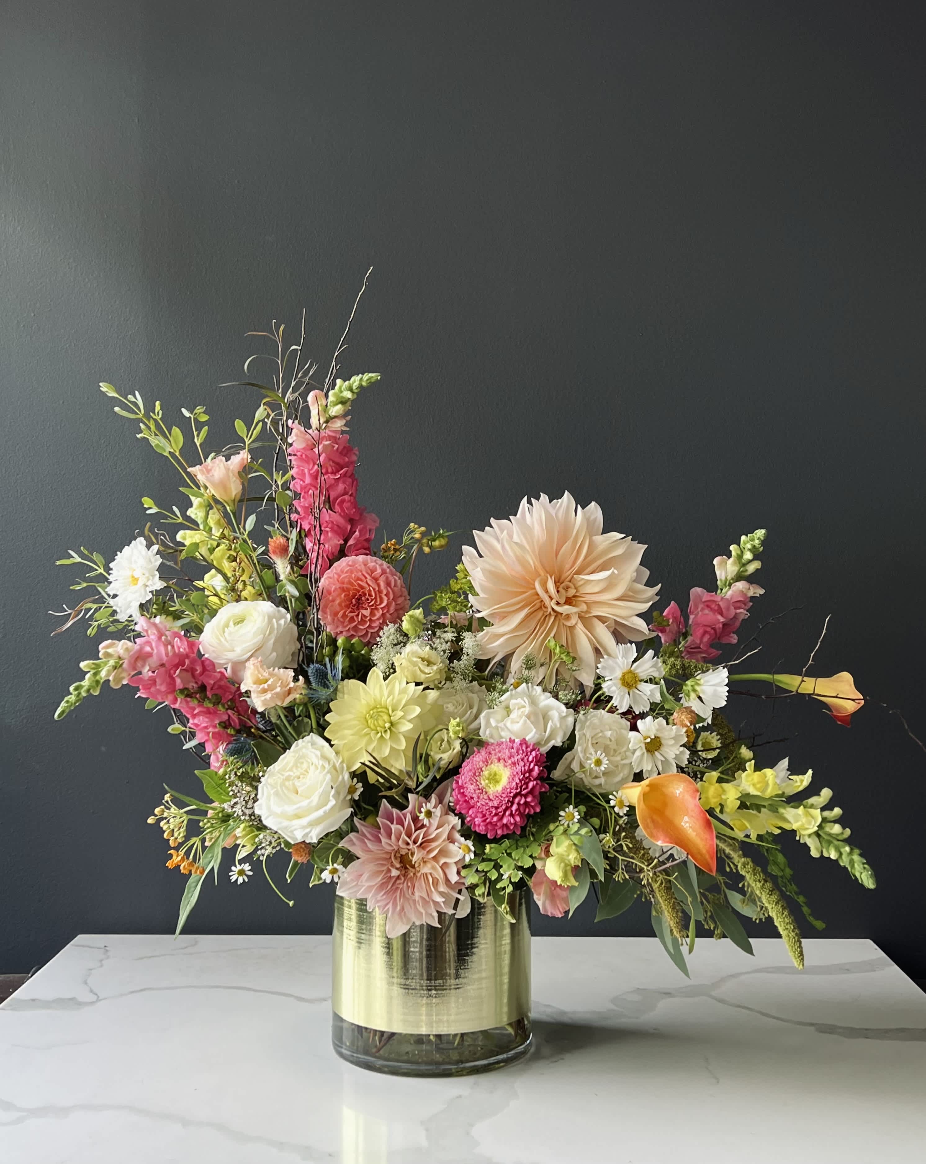 Blooming beauty - Beautiful arranged flowers  will make you heart skip a bit. Dahlias, mini cala Lilies, ranunculus, snapdragons will take you to the moon and back.  Available for next day delivery and pick up.