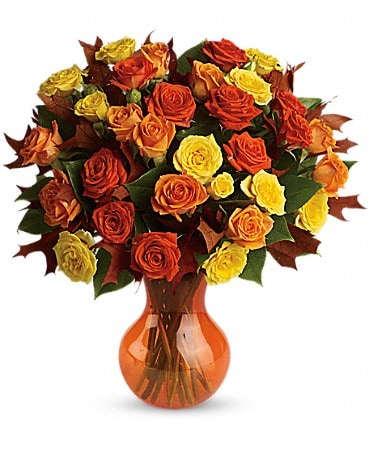 Teleflora's Fabulous Fall Roses - Autumn is a many-splendored thing, and this glorious bouquet is proof. The season's most amazing flowers in a chic serendipity vase - what a spectacular splash of color and style! Bask in it. Yellow, orange and light-orange spray roses - accented with preserved oak leaves and lemon leaf - are delivered in a sparkling orange Serendipity vase.