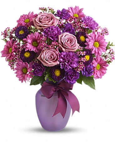 Purple and pink bouquet in a lavender vase with a ribbon