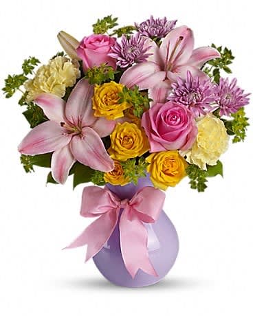 Teleflora's Perfectly Pastel - "Graceful and gorgeous" describes this stunning array of pastel flowers in a charming lavender vase. It's almost too pretty for words. But you'll hear many words of praise for sending it. The elegant bouquet features pink Asiatic lilies, yellow carnations, lavender cushion spray chrysanthemums, yellow spray roses and pink roses accented with assorted greenery. Delivered in a lavender vase.