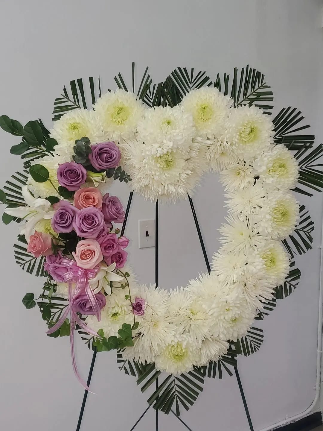 Heart-shaped floral wreath with white chrysanthemums and pink-purple roses