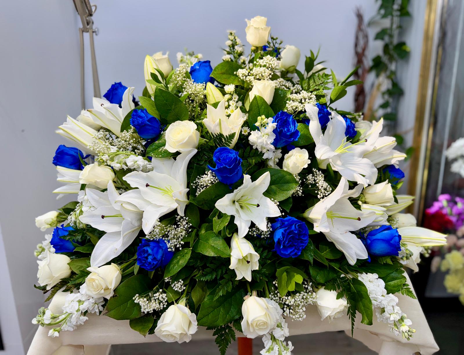Large bouquet of white lilies and roses with bright blue roses