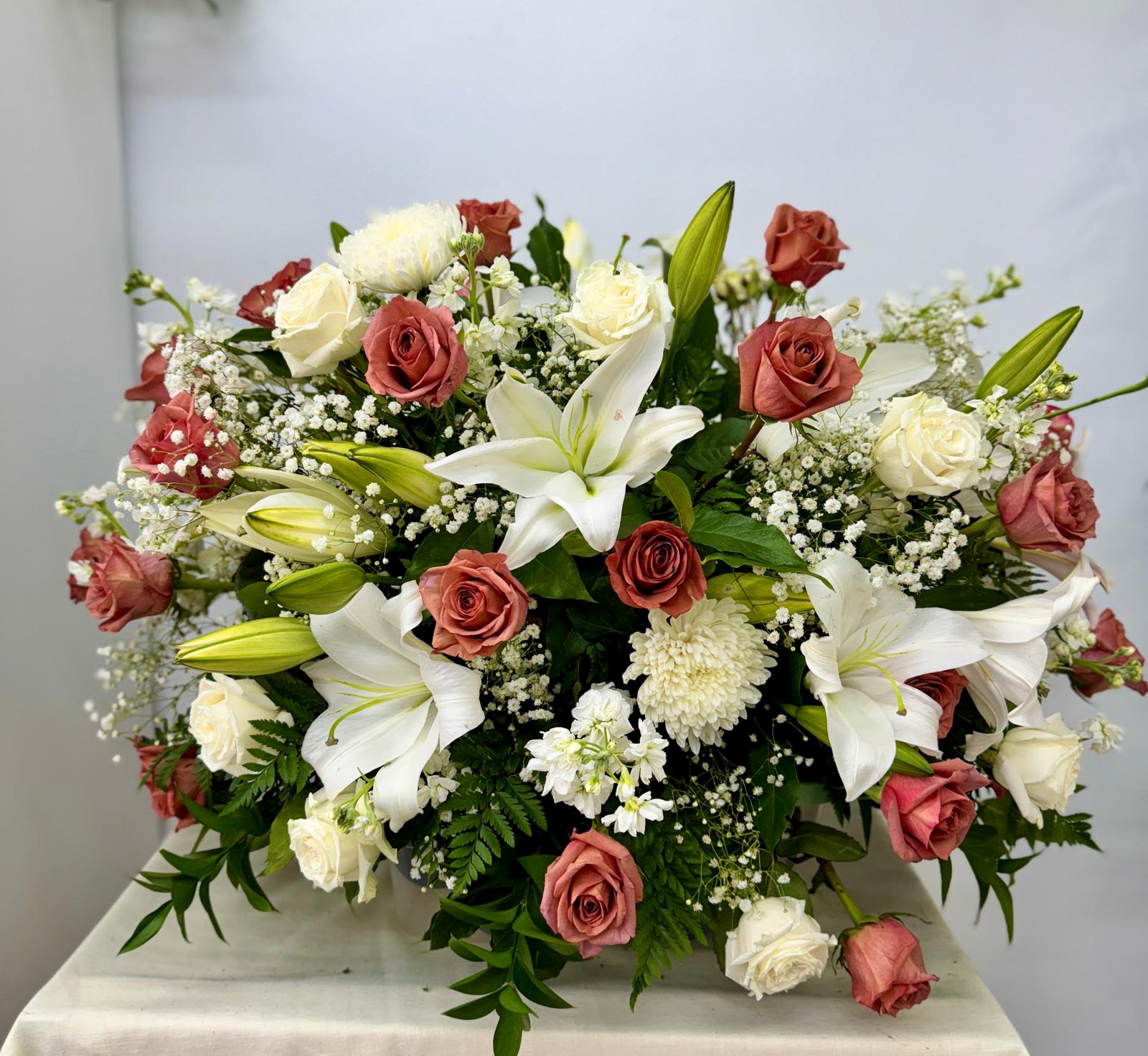 Large bouquet of white lilies and pink roses with baby's breath