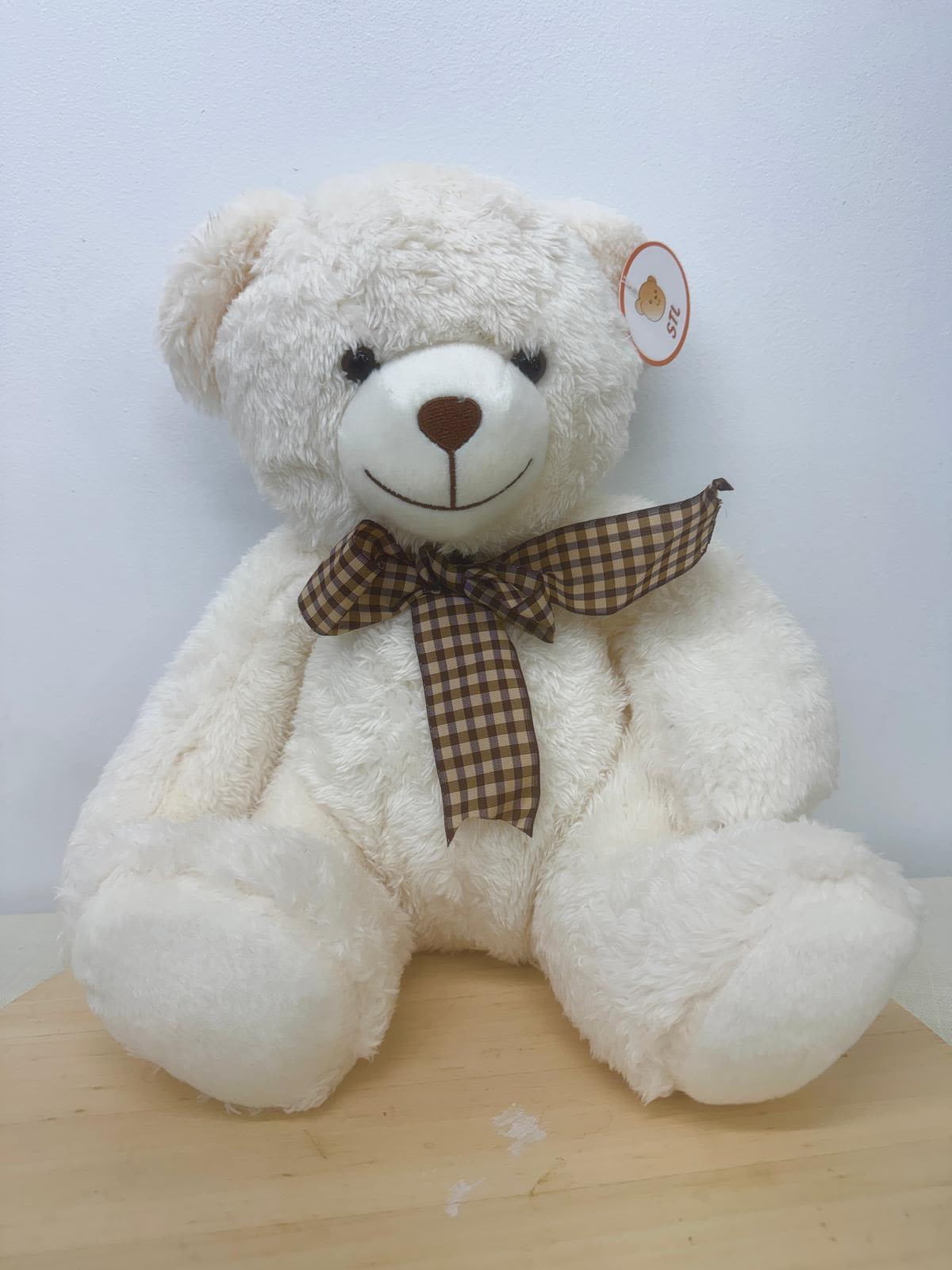 White teddy bear with a brown plaid ribbon bow