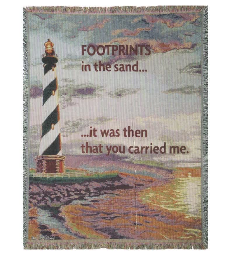 Printed blanket with a lighthouse and the words "Footprints in the sand"