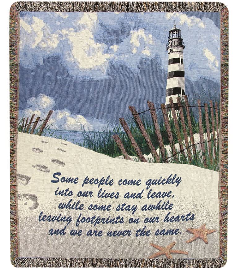 Woven blanket with a lighthouse scene and memorial quote