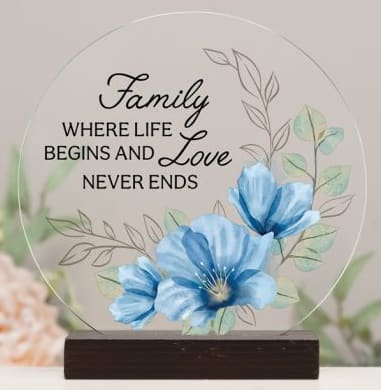 Decorative plaque with blue flowers and the words "Family where life begins and love never ends"