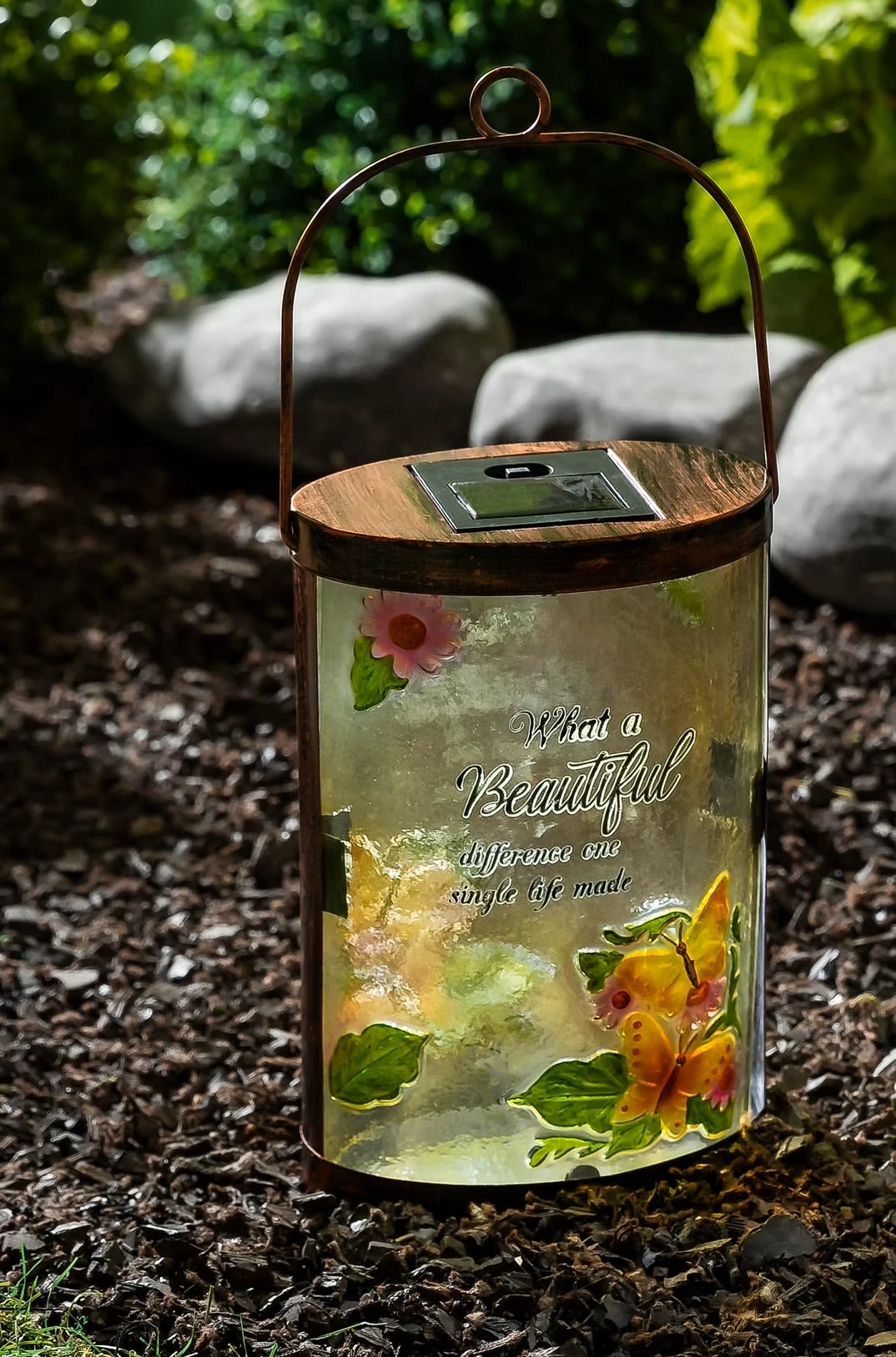Decorative solar lantern with butterfly and flower accents