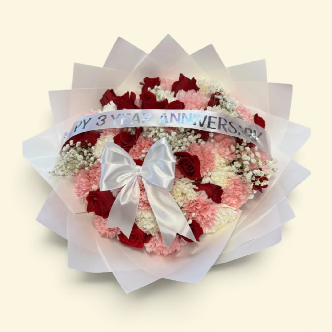 Red roses and pink carnations wrapped with a silver anniversary ribbon