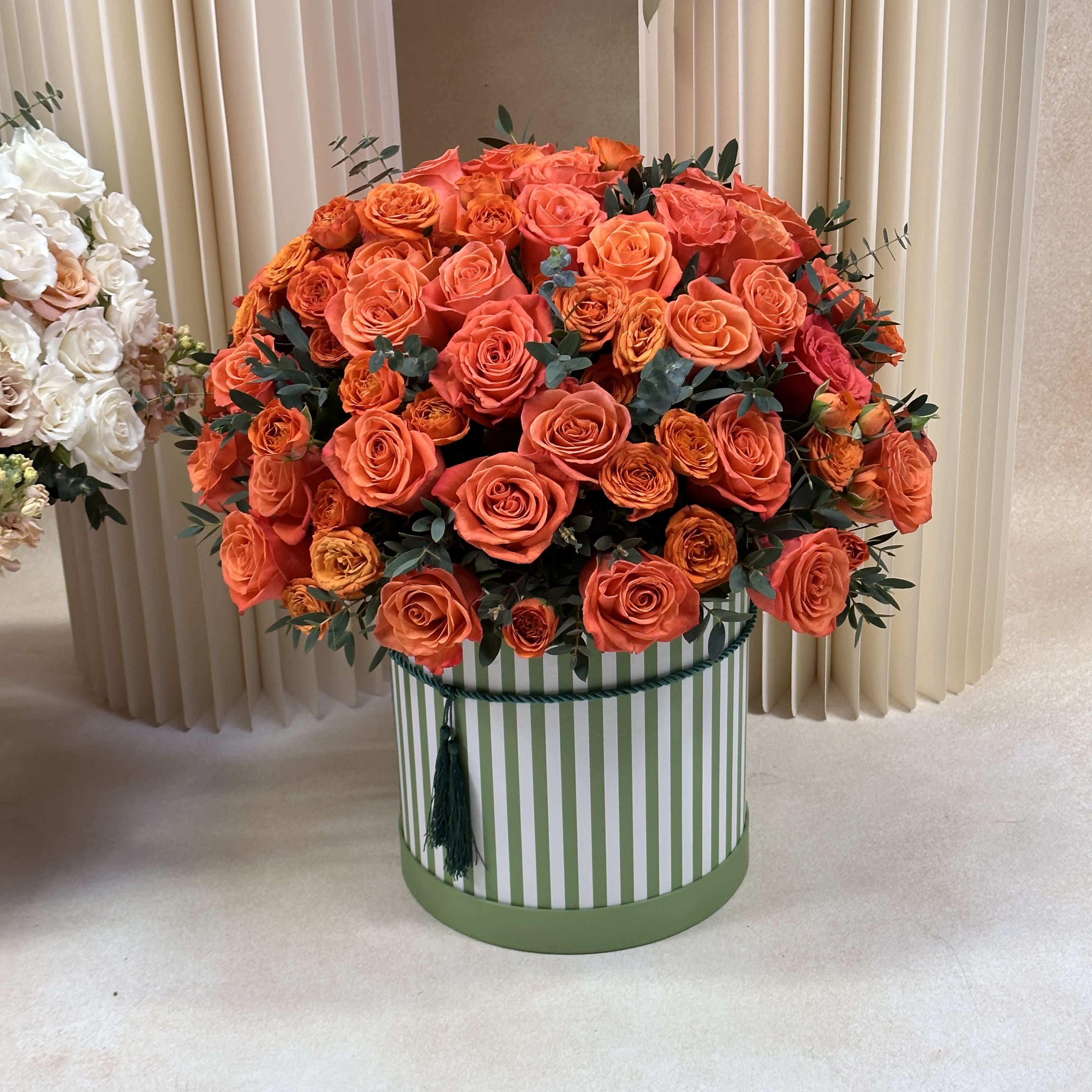 Orange Roses D - Vibrant and bold, our orange flower arrangements in a box ignite joy and warmth.  DELUXE size is shown in the photo.