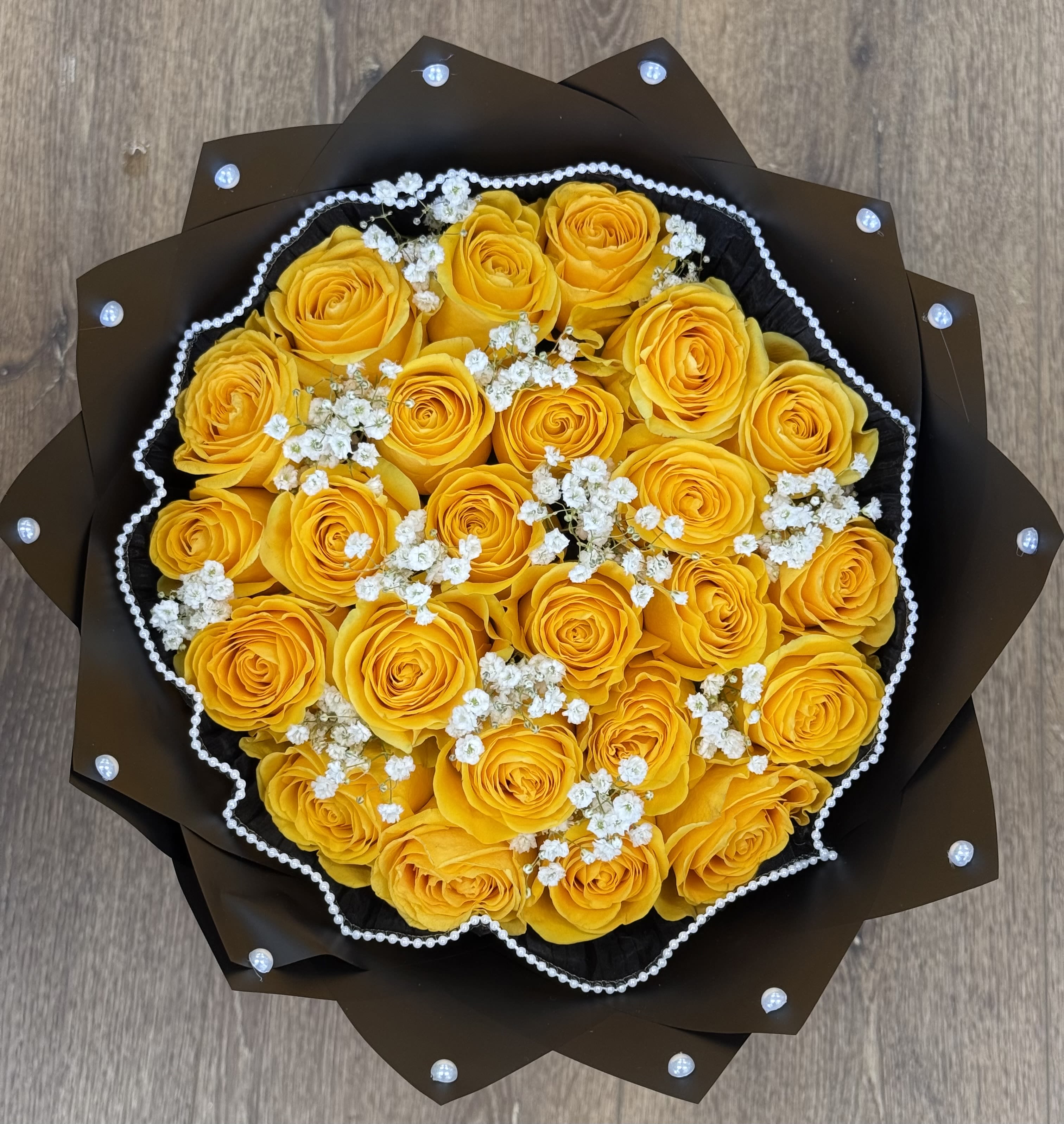 Yellow roses with Baby's Breath Bouquet - Yellow roses with baby breath and black paper. This arrangement also includes studded wrap and black mesh. (In-Store)
