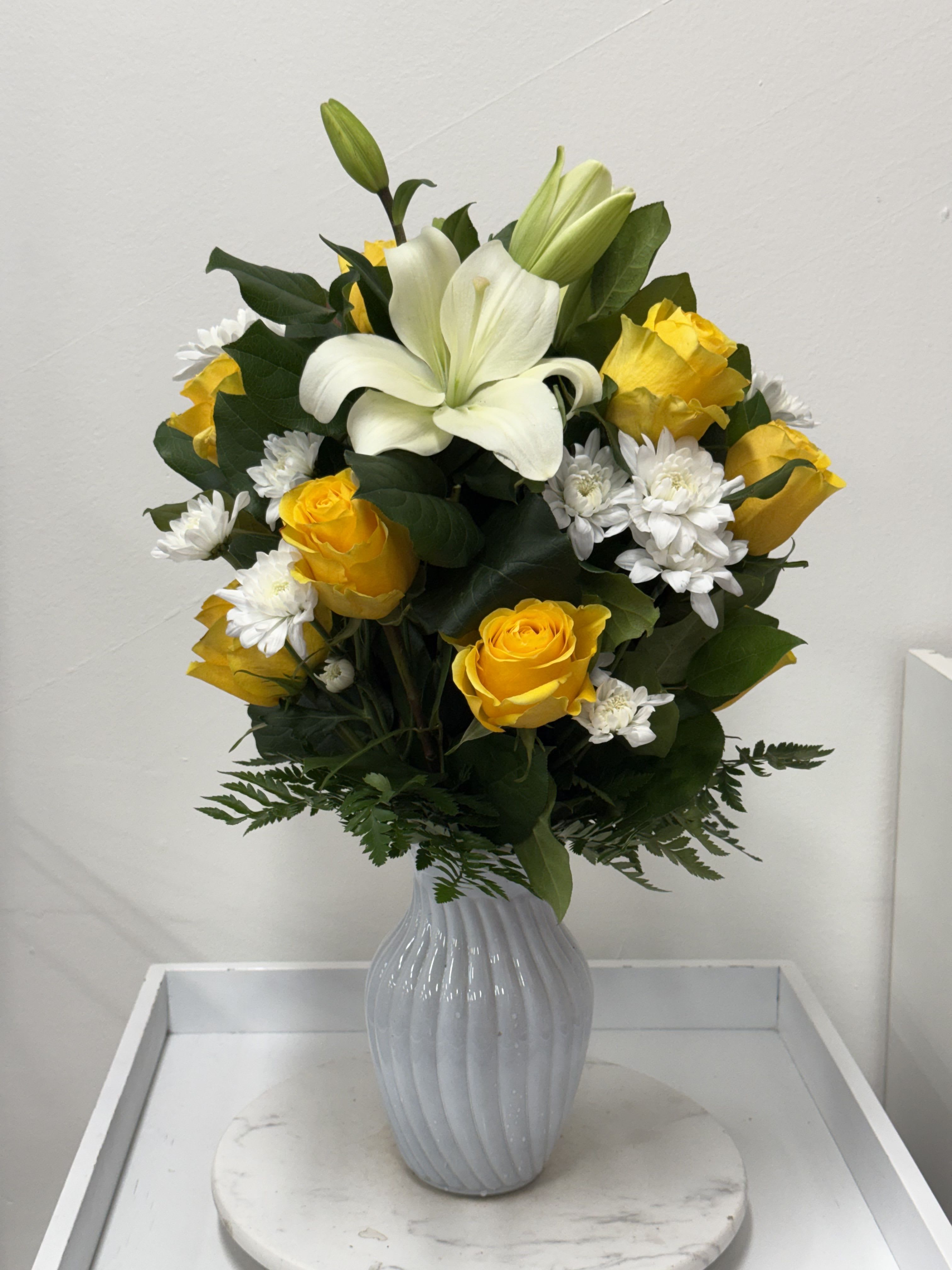 Yellow Rose vase Arrangements - Yellow Vase arrangement with greenery, white lilies, and white chrysanthemum in a white vase. (In-Store)