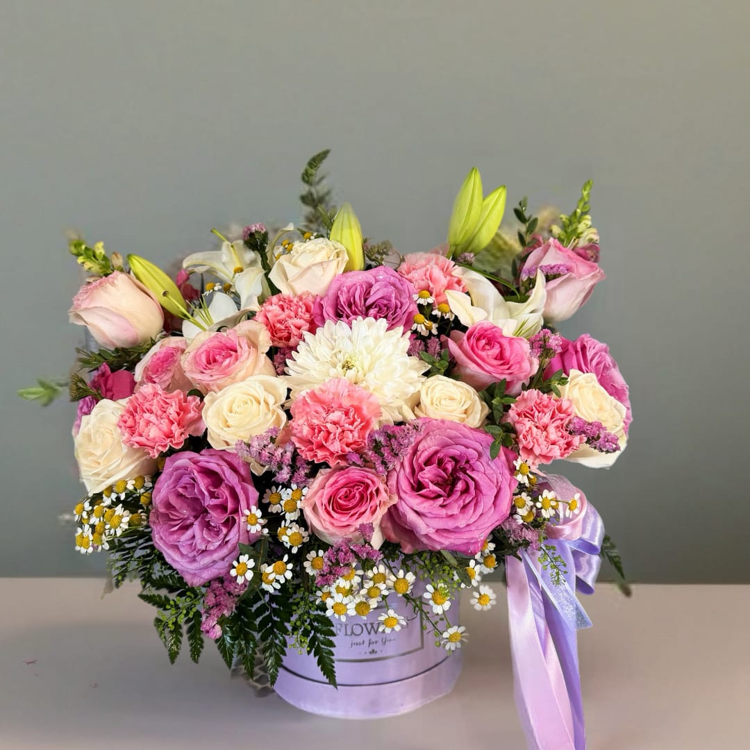 Chuy's Bouquet - The Chuy's Bouquet is an arrangement containing a blend of soft pink and bright white colors. The design brings together bright tones that blend with the greenery. The arrangement is a perfect gift for that important someone. Flowers included are roses, carnations, lilies, chamomile, and a mix of greenery