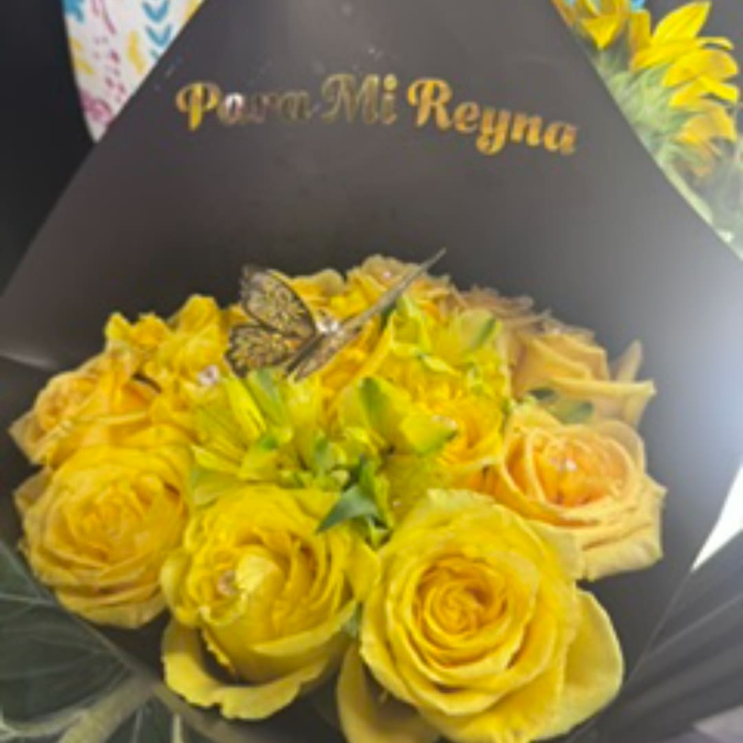 Yellow rose bouquet wrapped in black paper with a butterfly decoration