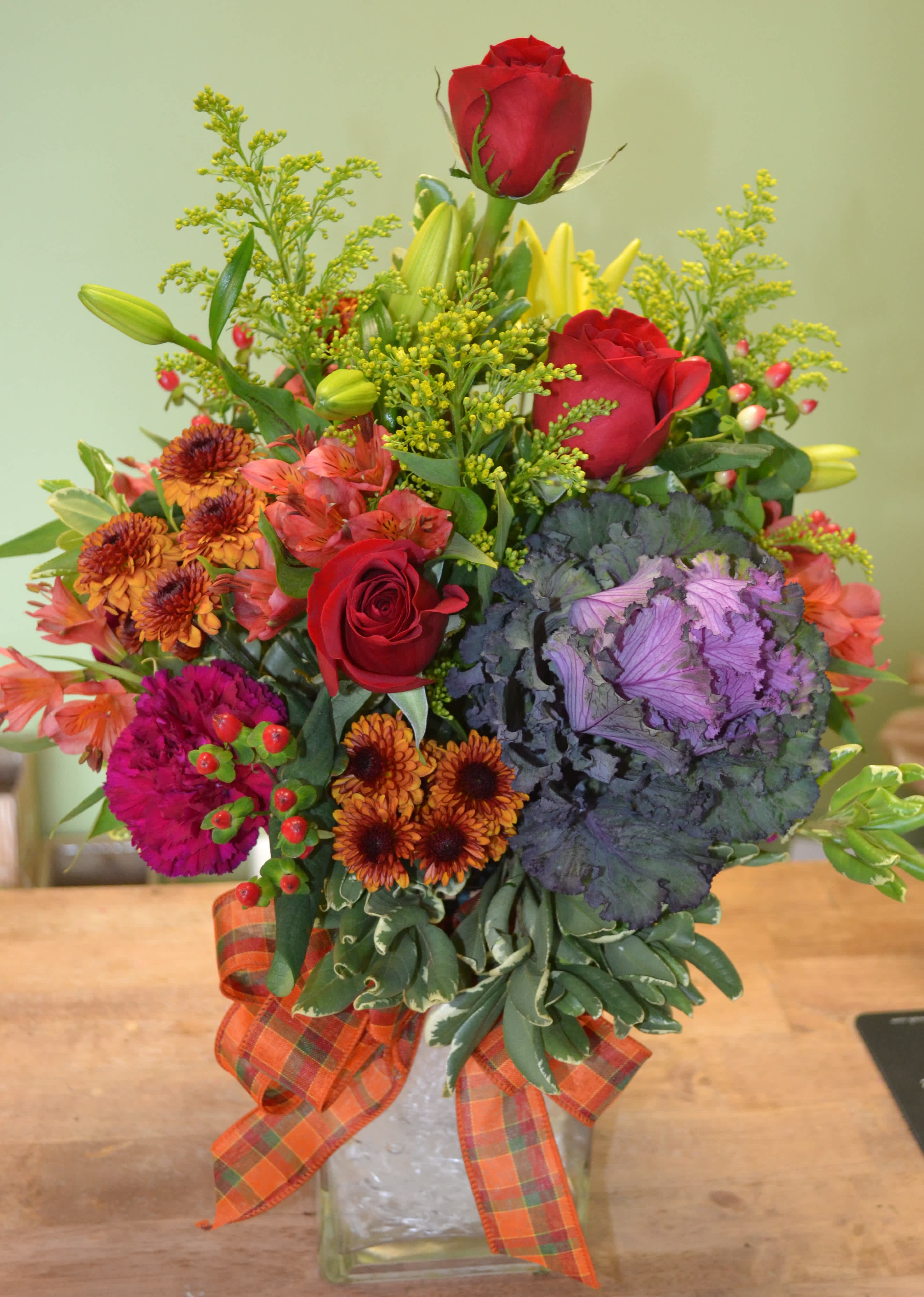 Harvest Celebration - This stunning arrangement has berries, poms, solidago, kale, carnations, roses, yellow lilies and more.