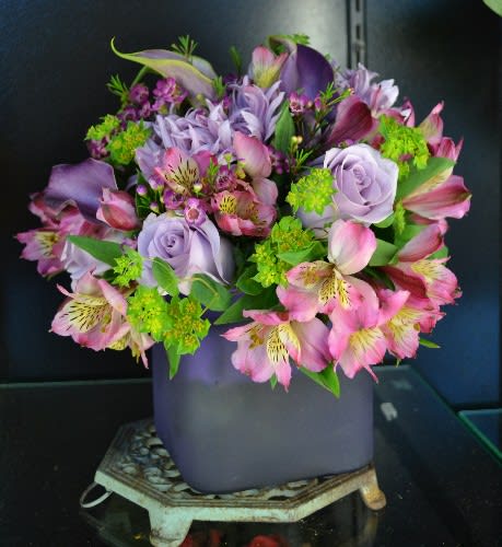 Purple and pink mixed bouquet in a lavender vase