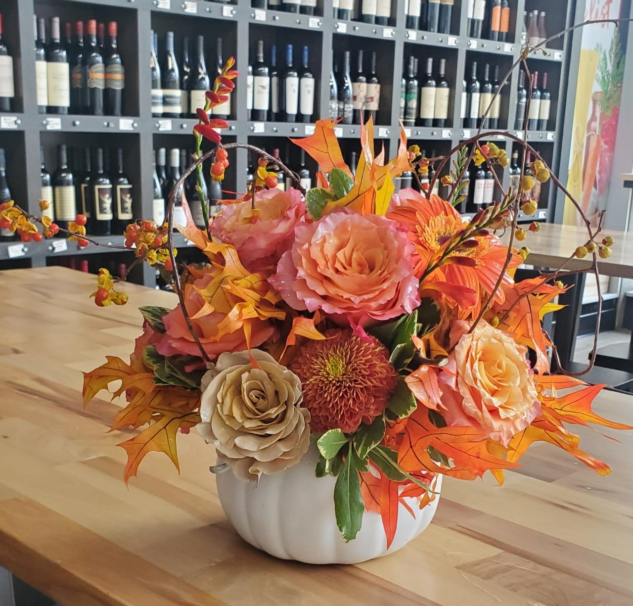 Harvest Centerpiece - Thanksgiving Day is complete with this bountiful centerpiece.  Includes garden roses, fall leaves, bittersweet vine and more fall goodies.  