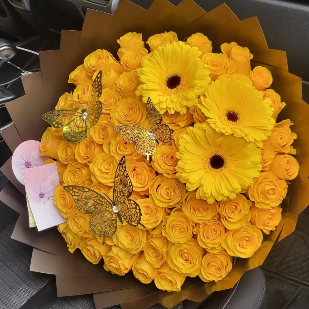 Yellow rose bouquet with three gerbera daisies and butterfly decorations
