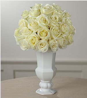The FTD® Special Blessings™ Bouquet - Elegant simplicity defines this extraordinary floral tribute that beautifully expresses what is in your heart at a time of profound sadness. An exquisite cloud of heavenly white roses, simply arranged by a local FTD artisan florist in a classic white urn vase, makes a stunning addition to a wake, funeral or graveside service. Its loveliness can provide much appreciated and long remembered comfort when sent to the family home.  Your purchase includes a complimentary personalized gift message.