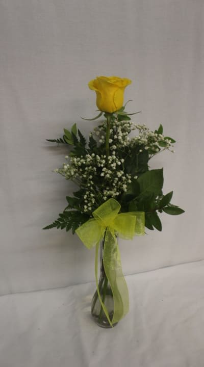Yellow rose in a glass vase with baby's breath and ribbon