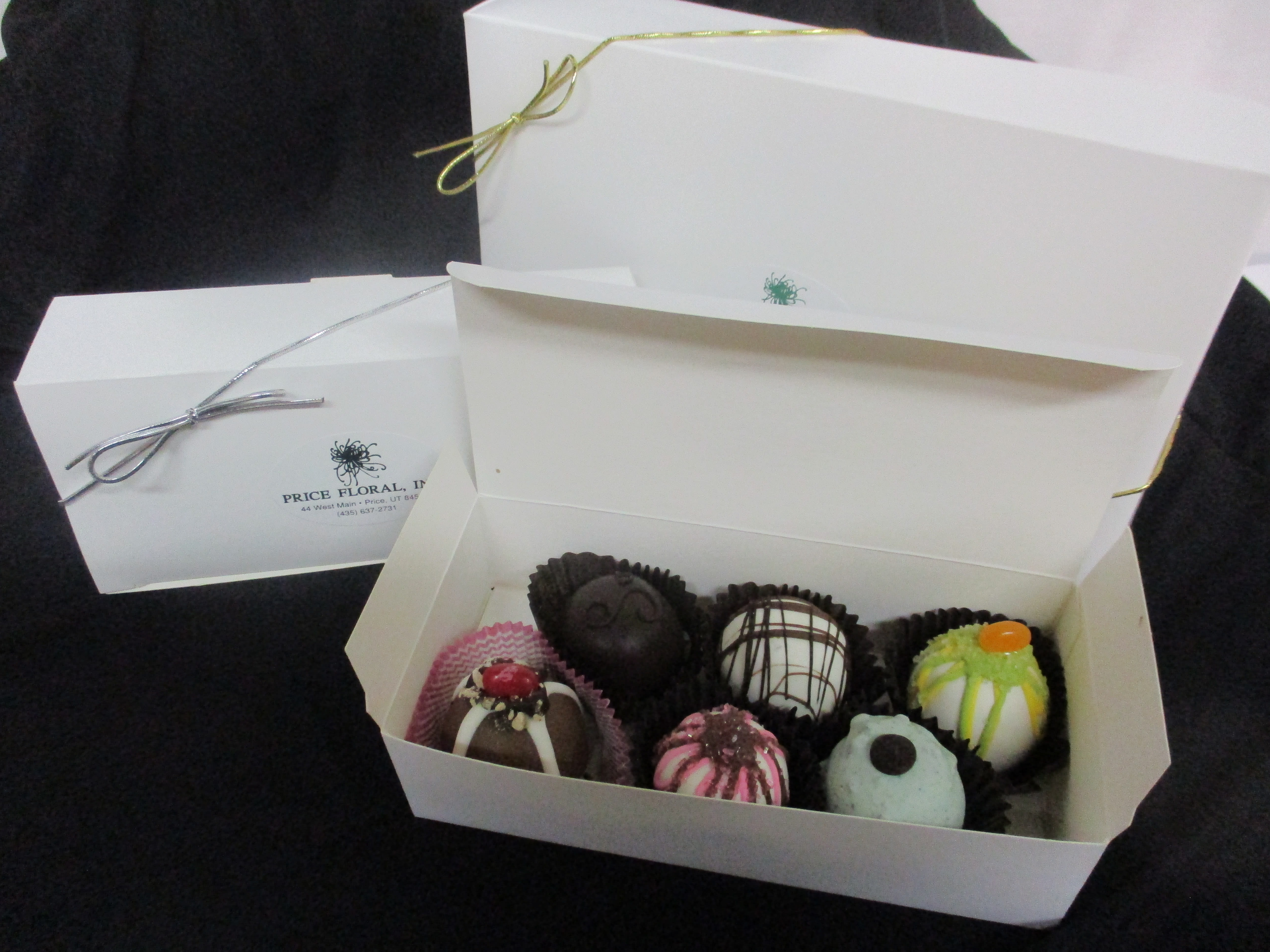 Box of assorted decorated chocolates in white gift boxes