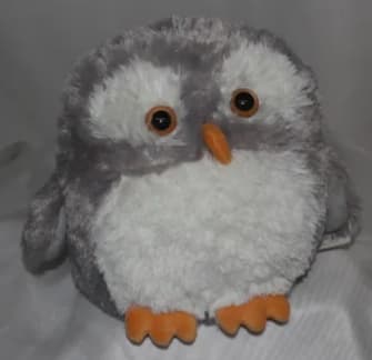 Plush gray-and-white owl toy with orange beak and feet