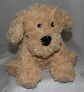 A beige plush dog toy with floppy ears and black eyes.