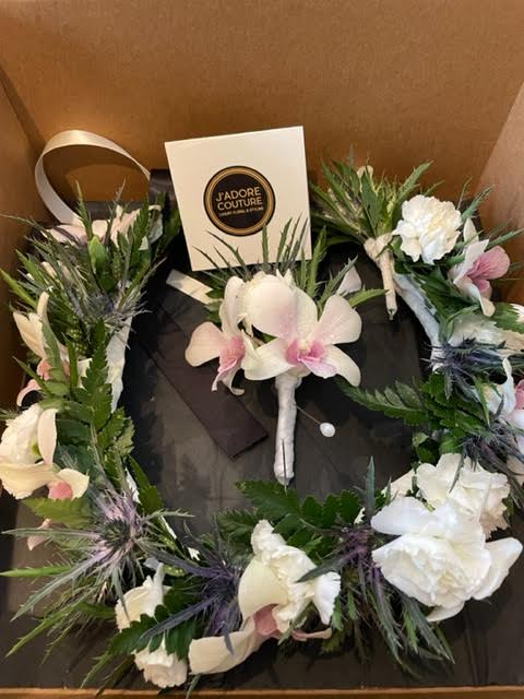 Floral wreath with white and pink orchids in a gift box