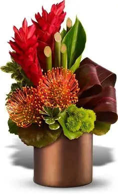 Red and orange tropical flowers in a bronze vase