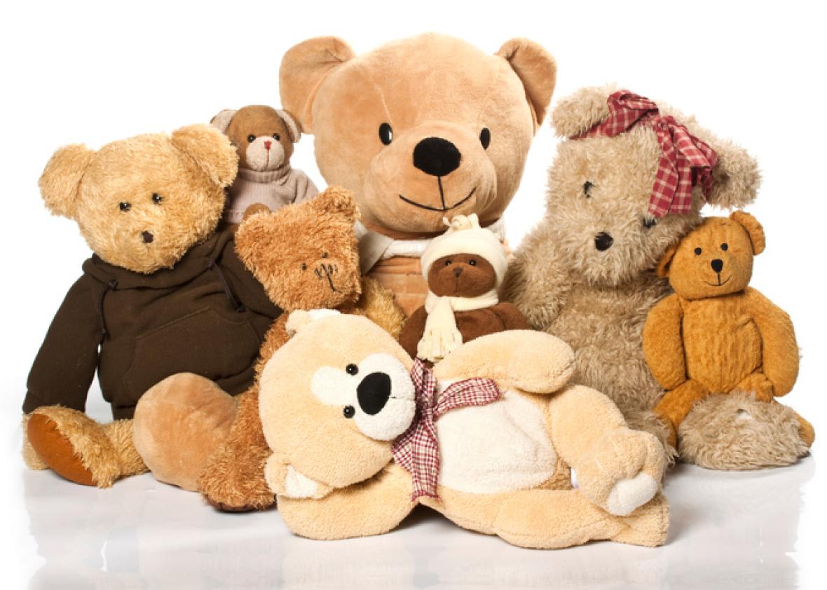 Assorted teddy bears posed together on a white background